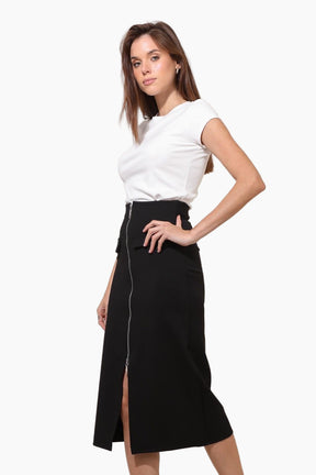 Woman wearing a white top and black skirt 