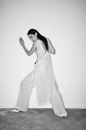 Person wearing a white outfit with wide-leg pants 