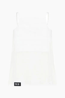 White slip dress with a brand label on a white background
