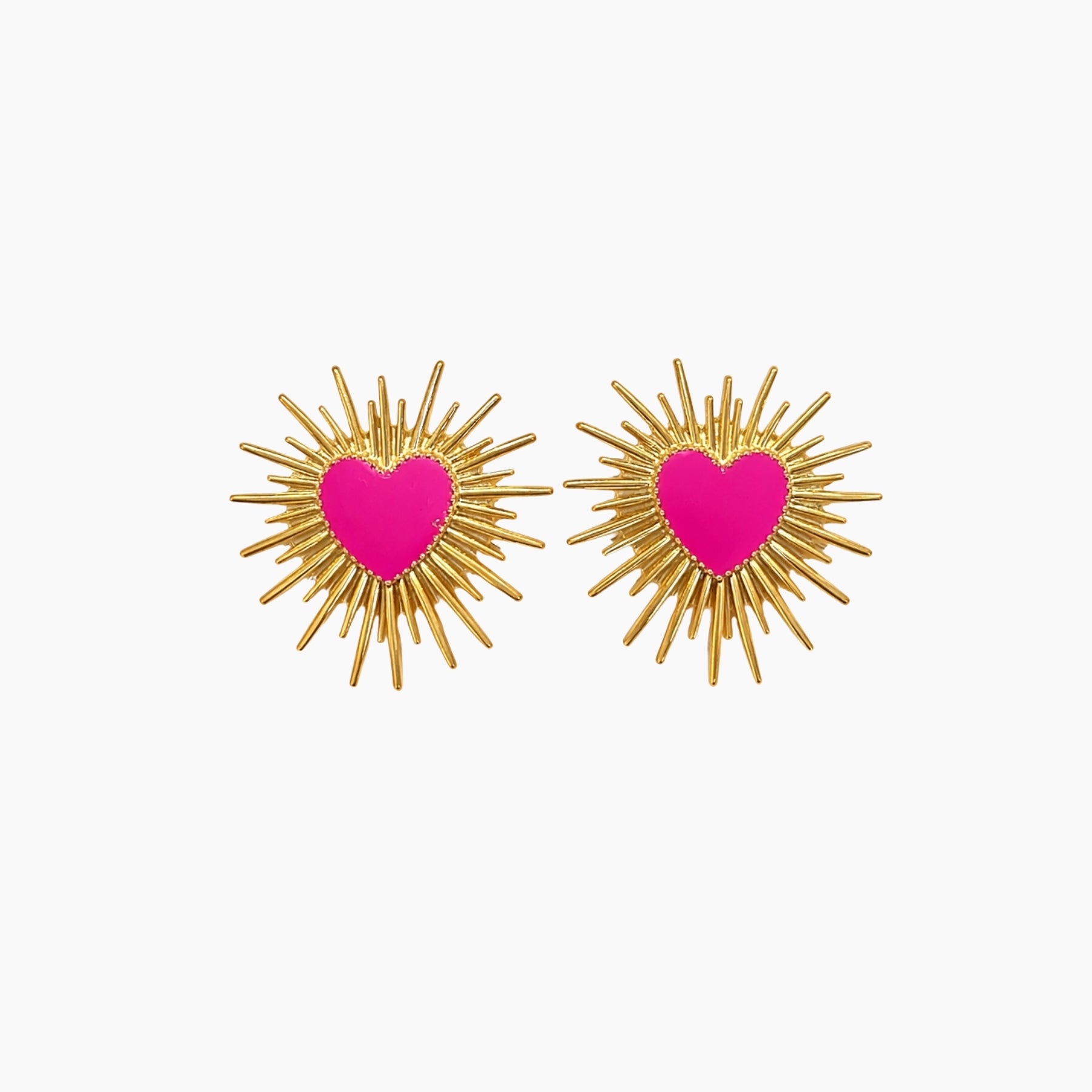 Pair of earrings with pink heart centers and gold辐射 designs on a white background