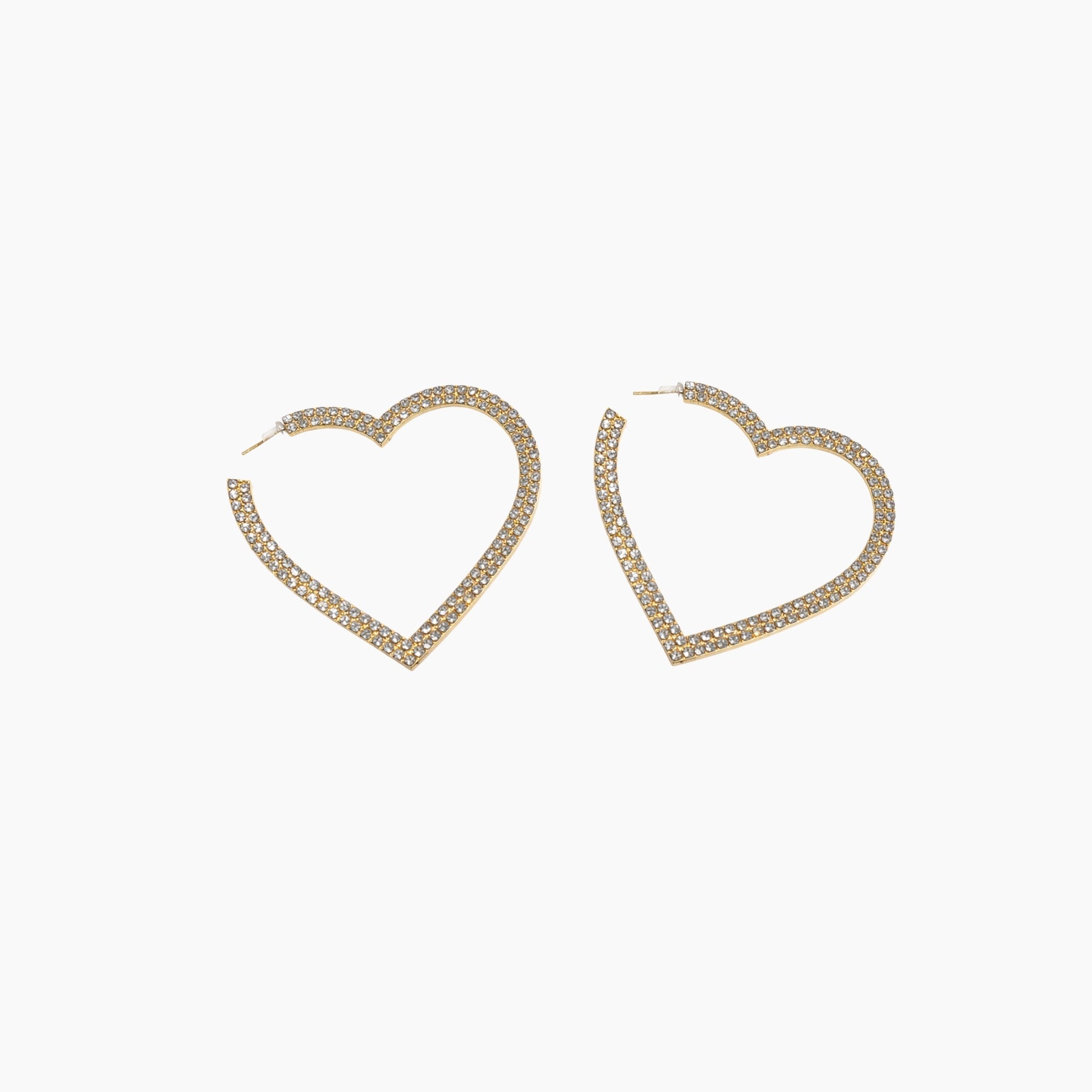 Heart-shaped gold earrings on a white background