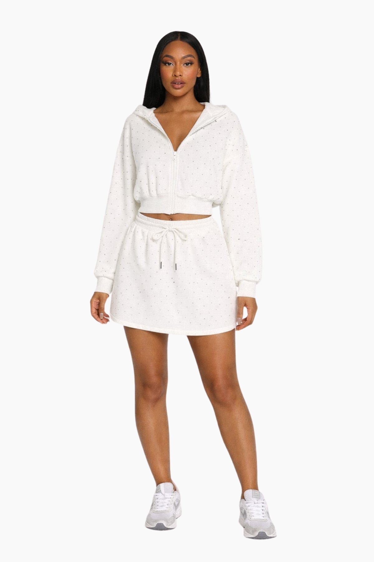 Woman wearing a white hoodie and shorts set on a white background