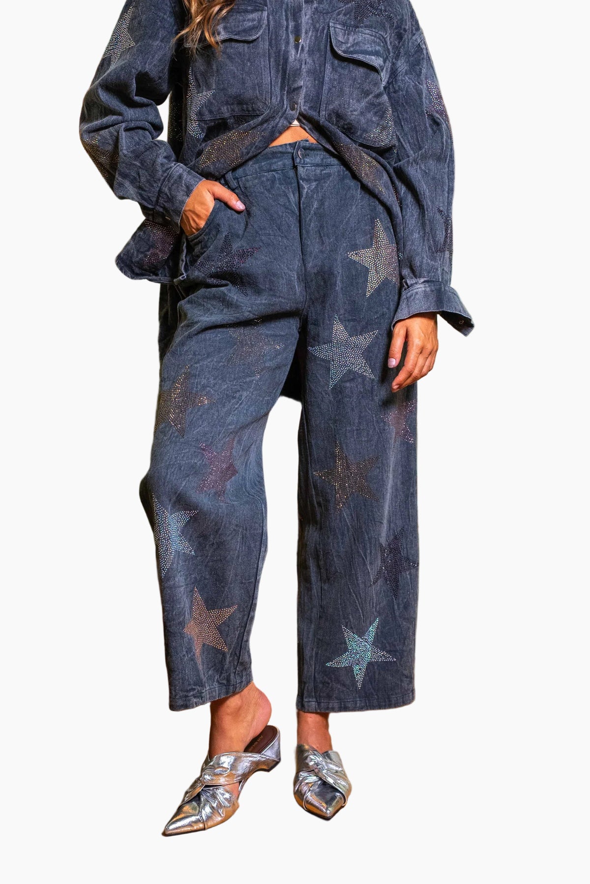 Person wearing a dark blue denim outfit with star patterns .