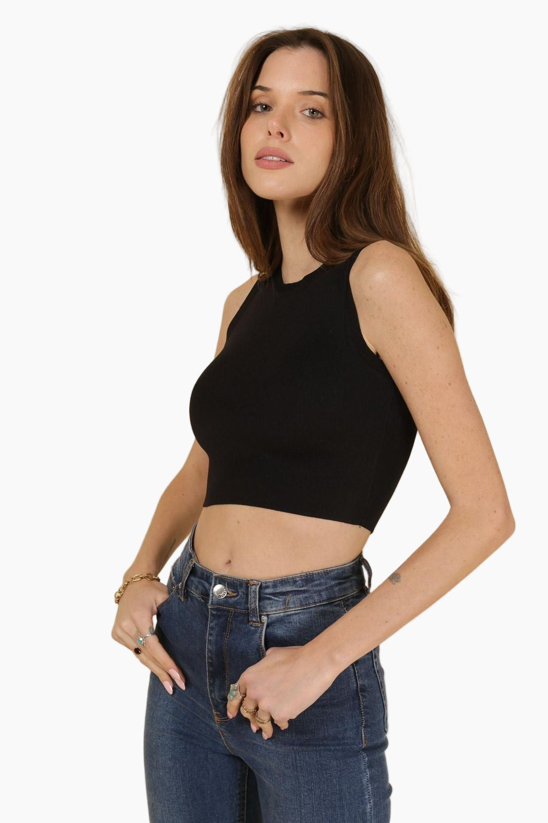 Woman wearing a black sleeveless top and blue jeans 
