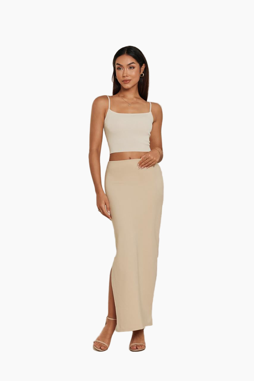 Woman wearing a beige top and skirt set 