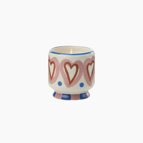 Ceramic candle holder with heart design on a white background