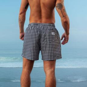 Man wearing black and white houndstooth patterned shorts