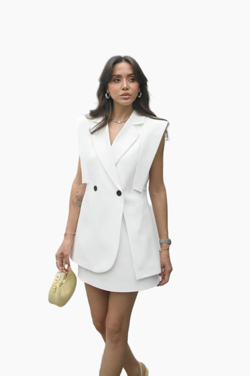 Woman wearing a white sleeveless blazer dress on a white background