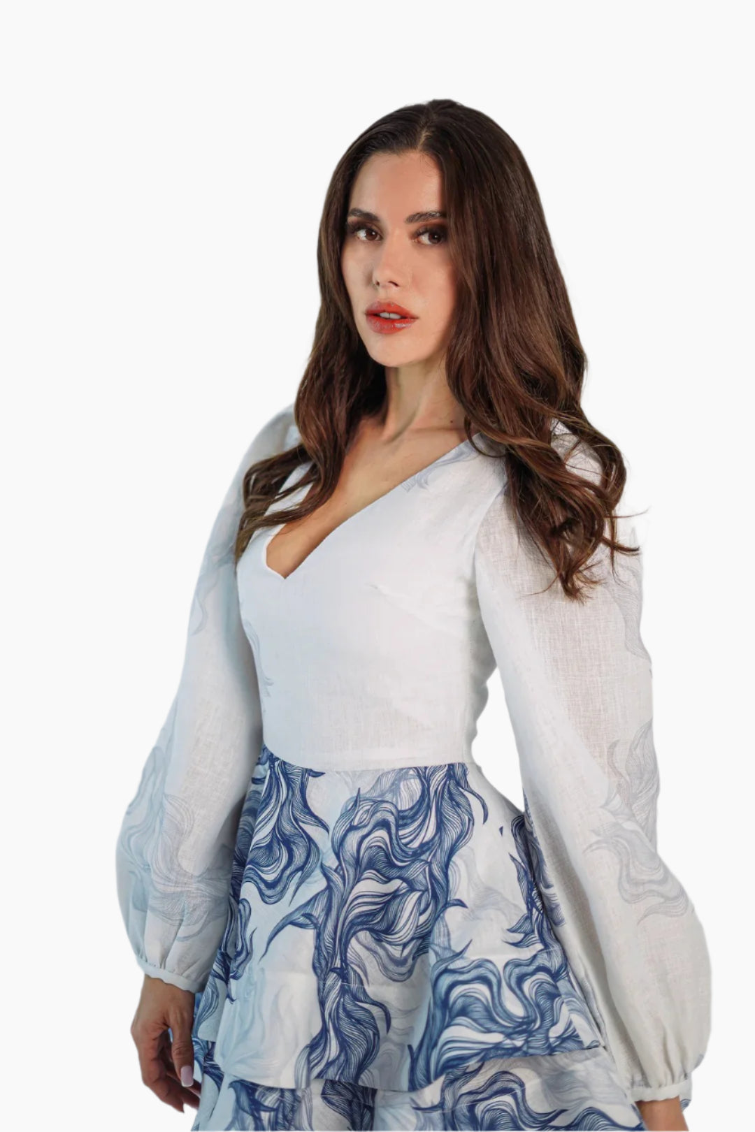 women wearing a short linen dress, long and puffed sleeves, featuring a  ruffle skirt.