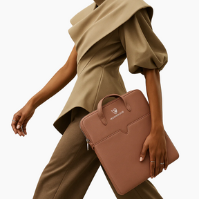 Person holding a pink handbag with a neutral background