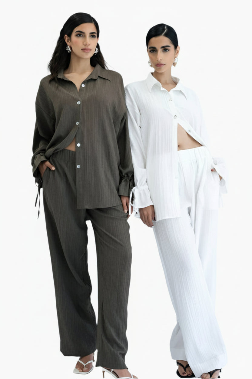 Two women wearing contrasting outfits.