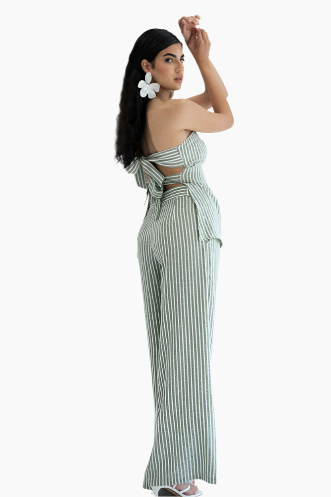 Woman wearing a green and white striped jumpsuit 
