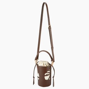 Brown leather crossbody bag with white floral pattern on a white background