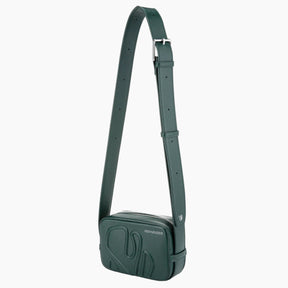 Green crossbody bag with a strap on a white background