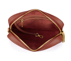 burgundy leather pouch with gold zipper on a white background