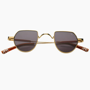 Gold-framed sunglasses with dark lenses 