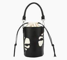Black bucket bag with white paw print design on a white background