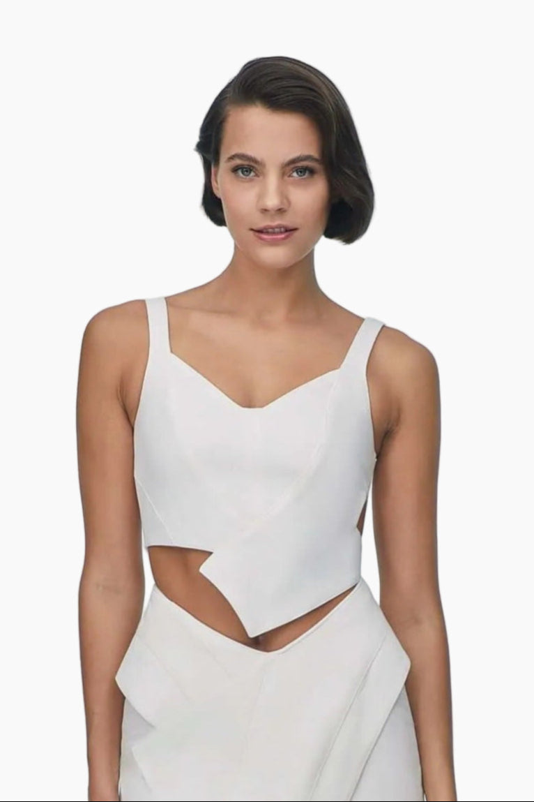 Woman wearing a white sleeveless top with cut-out design 