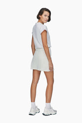 Woman wearing a white t-shirt and  denim mini skirt 