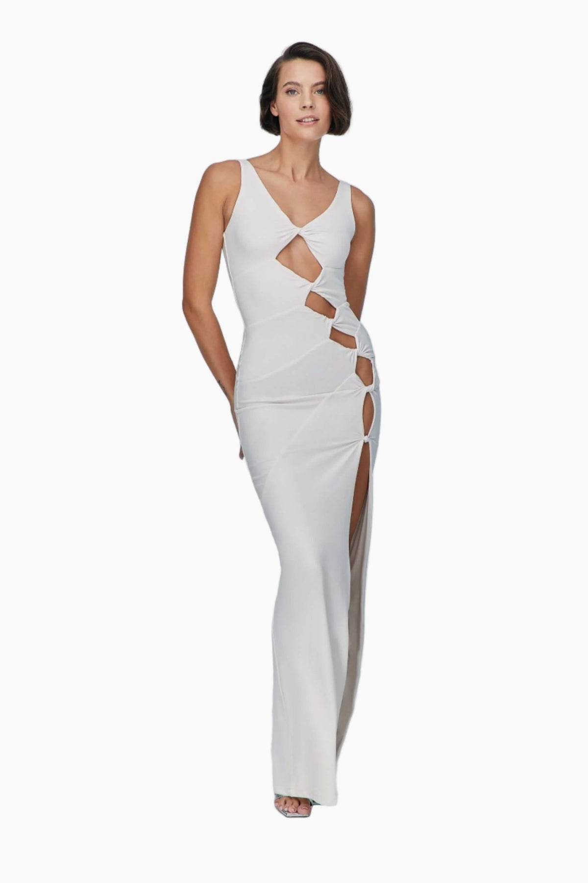 Woman wearing a white evening gown with cut-out design 