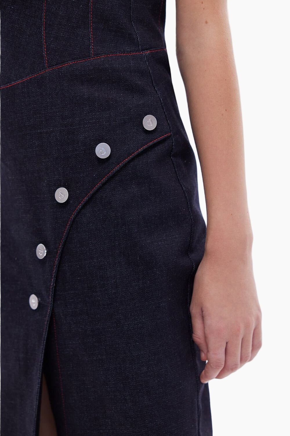 Close-up of a dark denim dress with button details 