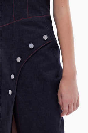 Close-up of a dark denim dress with button details 