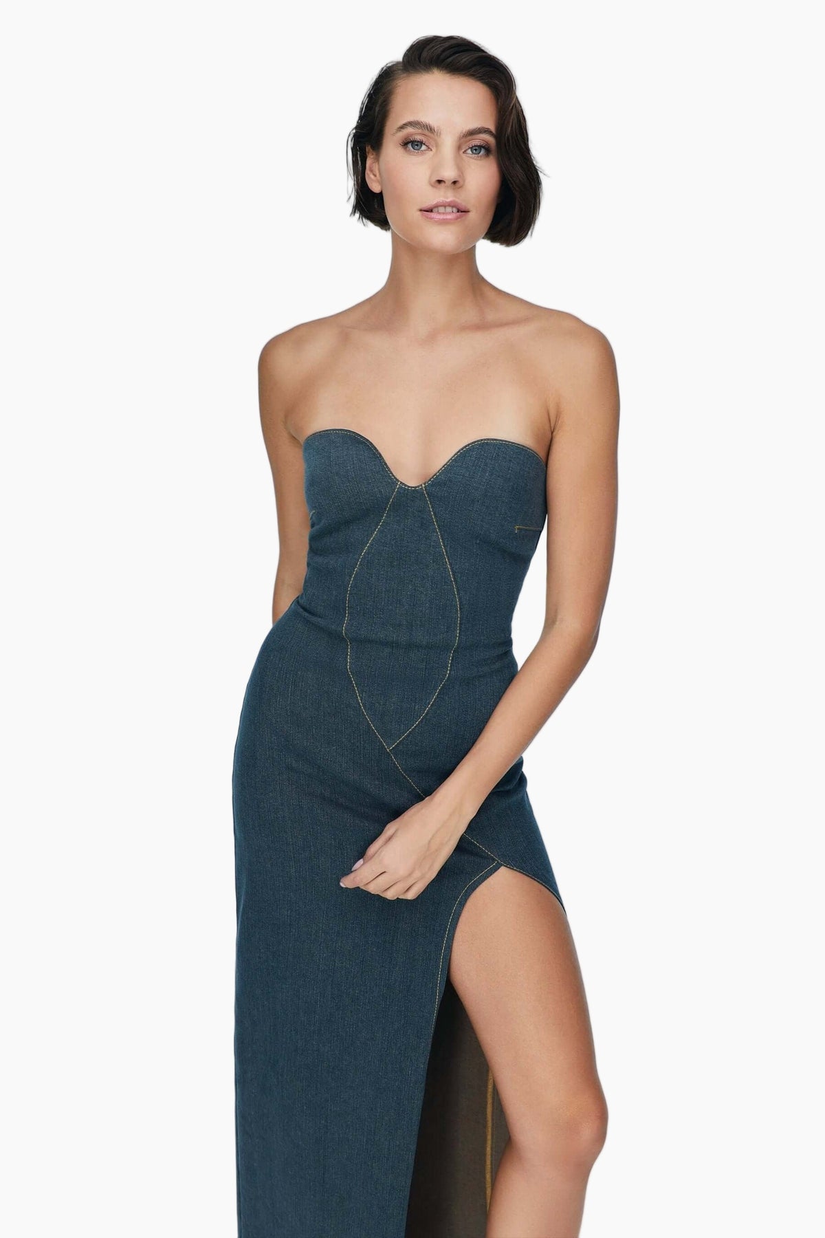 Woman wearing a strapless teal dress with a slit 