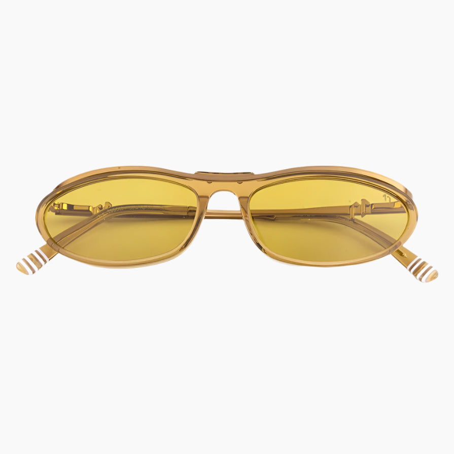 Gold-framed sunglasses with yellow lenses on a white background