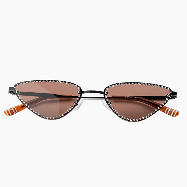 Sunglasses with decorative frame and brown lenses on a white background