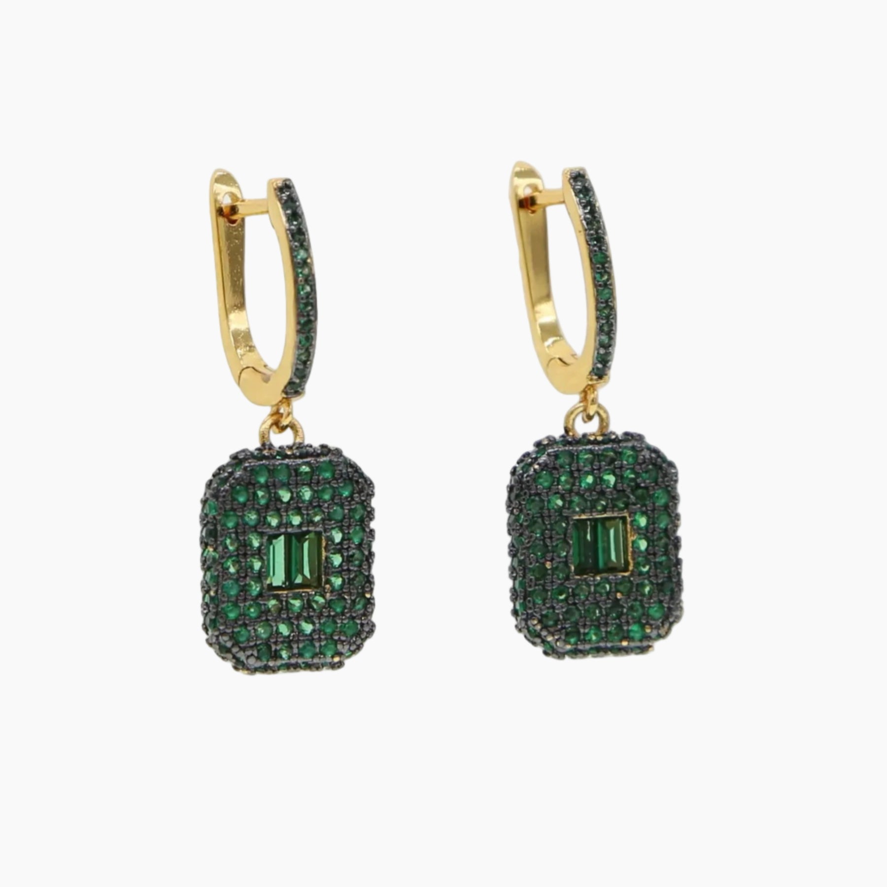 Gold hoop earrings with green gemstones on a white background
