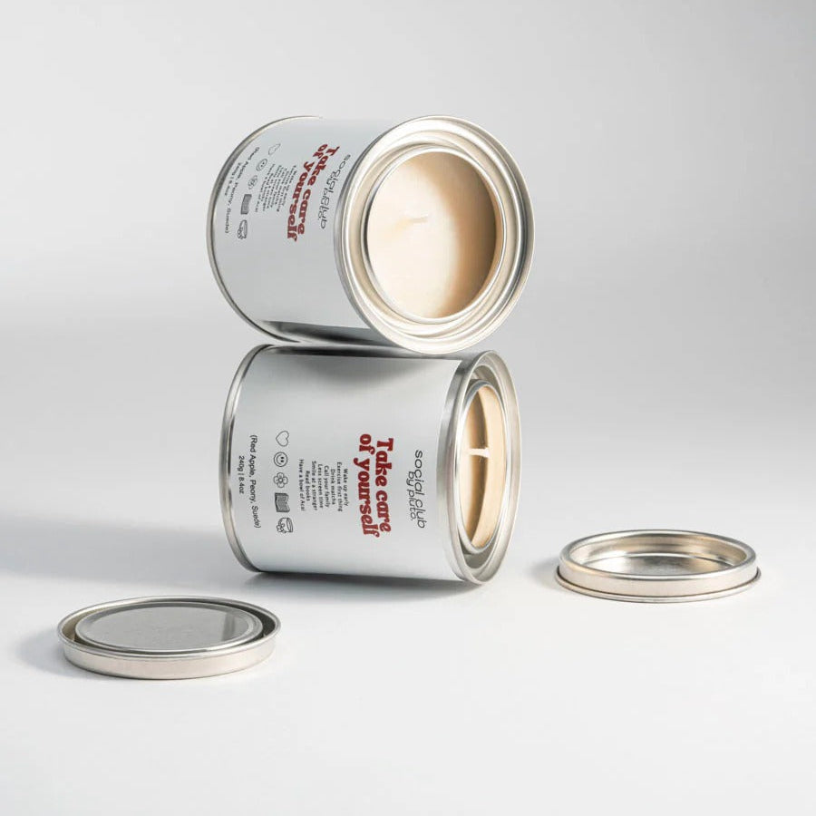 Two cans of paint with open lids on a gray background
