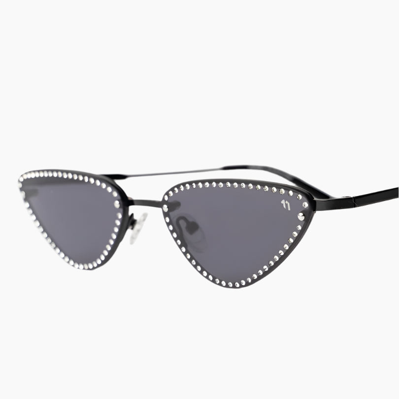 Cat-eye sunglasses with decorative frame on a white background