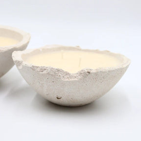 Two stone-like bowls with candles inside 