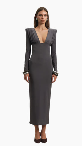 Woman wearing a gray evening gown with long sleeves 