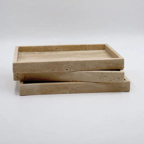 Two beige stone trays stacked on a white background