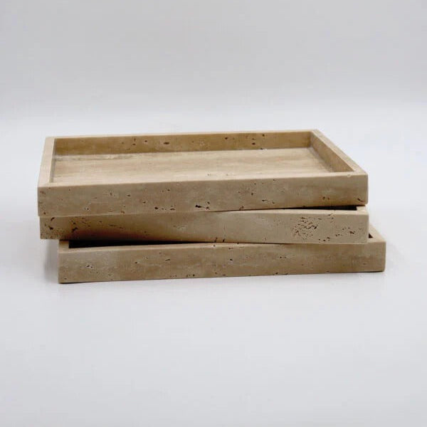 Two beige stone trays stacked on a white background