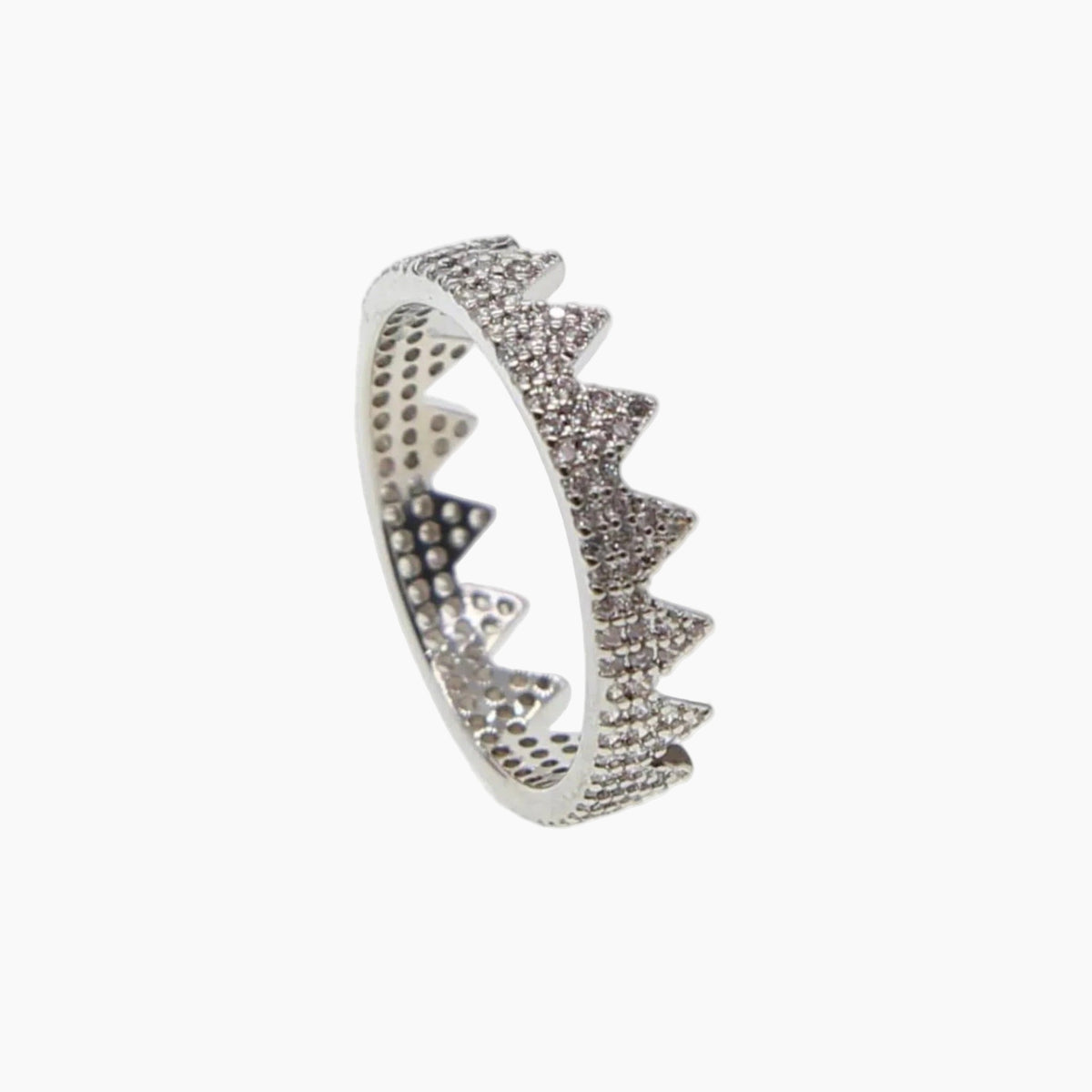 Silver ring with a shark tooth design on a white background