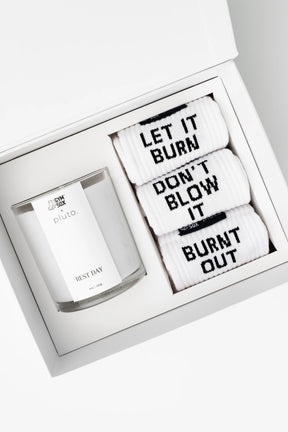 Set of candles with motivational phrases in a white box