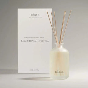 Fragrance diffuser with reeds and packaging labeled 'pluto' on a neutral background