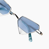 Sunglasses with blue lenses and silver frame on a white background