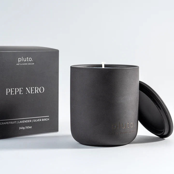 Black candle with lid and 'pluto' branded box 
