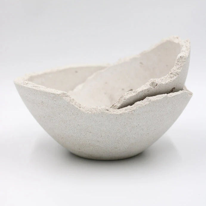Two concrete bowls on a white background