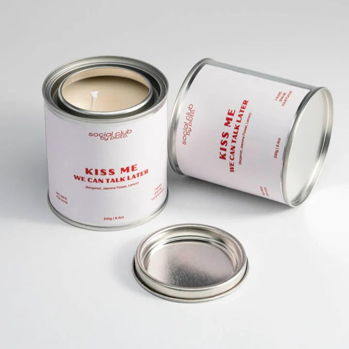 Candle in a can labeled 'Kiss Me We Can Talk Later' by Social Club Dupe on a white background