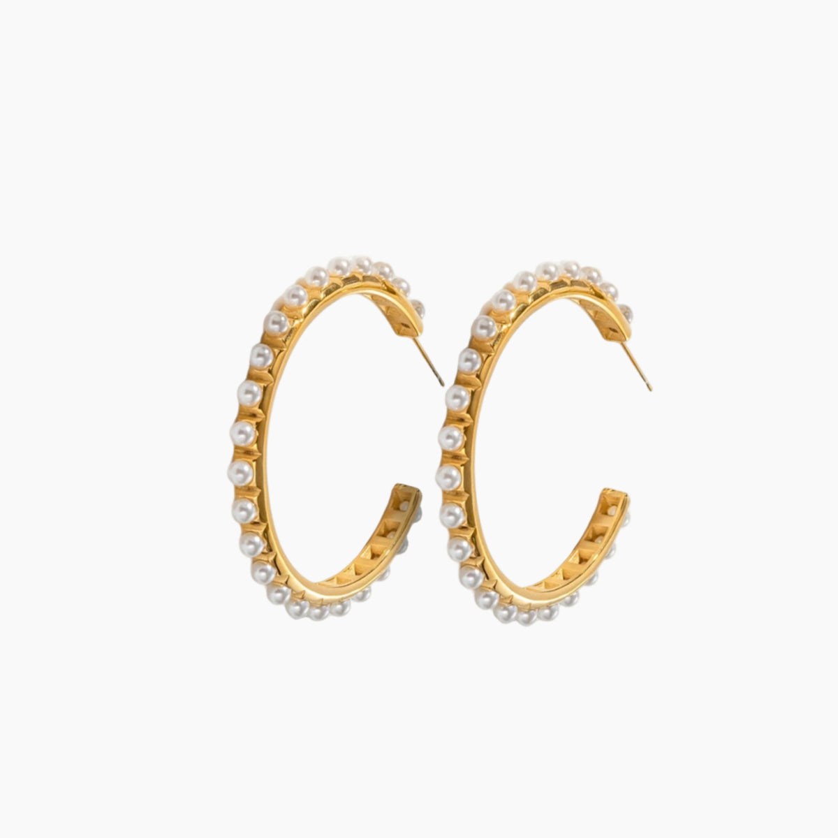 Gold hoop earrings with embedded pearls on a white background