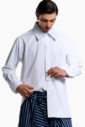Person wearing a white shirt and blue striped pants on a plain background