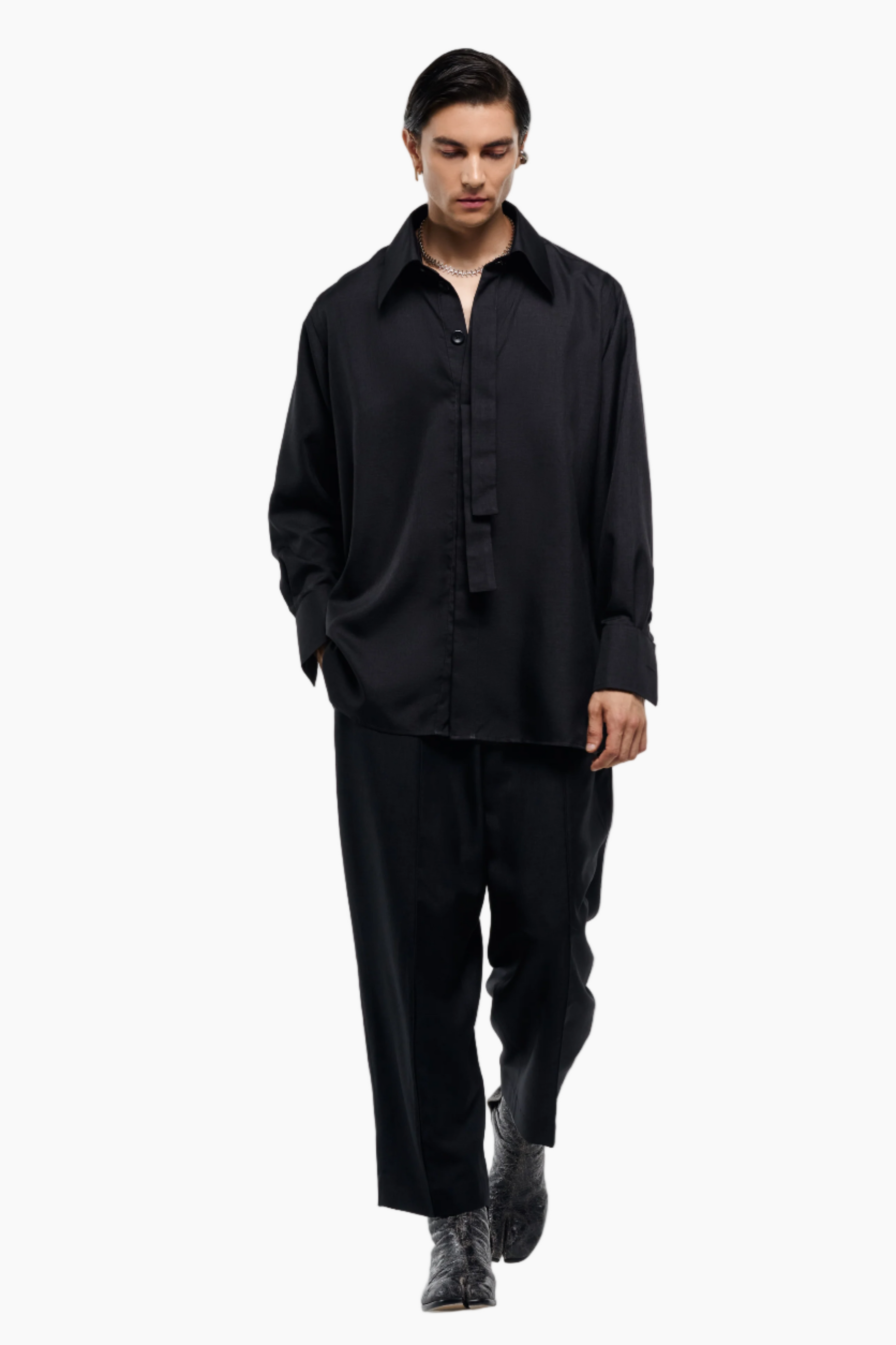Man wearing a black outfit on a white background