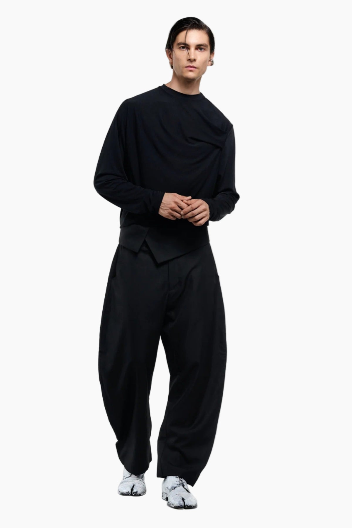 Person wearing a black outfit on a white background