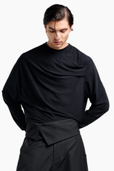Person wearing a black outfit black top and pants 