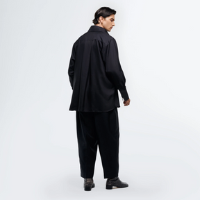 Person wearing a black outfit on a white background