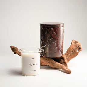 Candle labeled 'Fig Noir' with a decorative container 